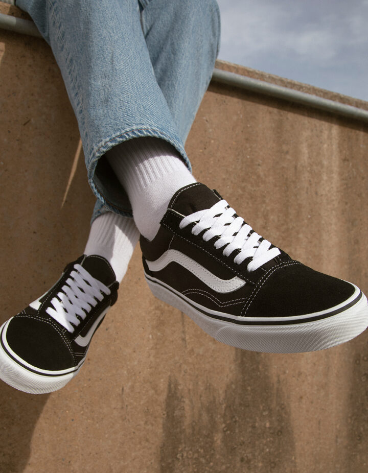 Classic Black Vans Old Skools with White Socks and Blue Jeans