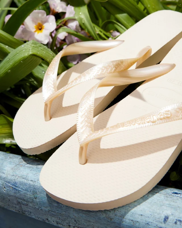Summer starts here... with up to 25% off 🌴

Shop the hottest sandals styles from all your favourite brands, online and in-store now. 

Be quick, this offer won’t stay forever! 👀

Selected styles only.
T&Cs Apply.

ID: An image of a pair of beige Havaianas Top Senses Flip sandals sitting in a blue flower pot on top of a green and pink flower plant.